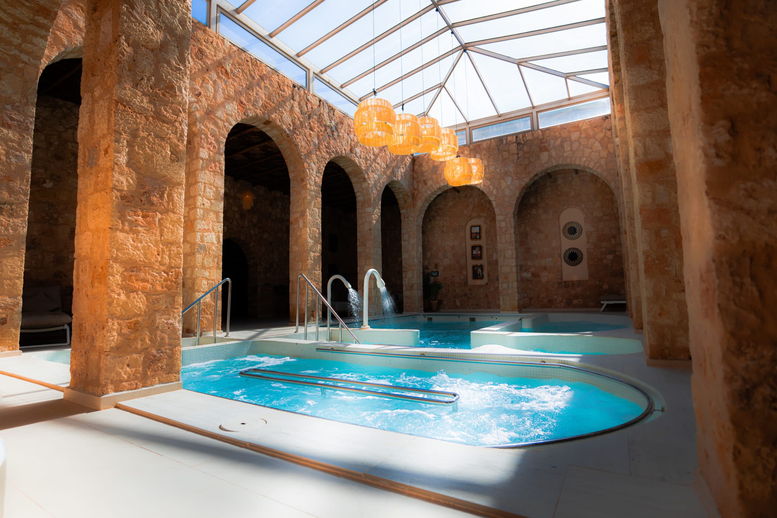 Dakhla Club spa indoor pool with stone arches